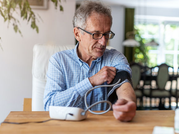 an old man is measuring his blood pressure