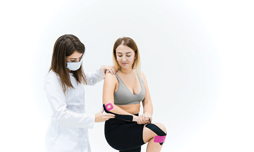 A Medical Practitioner Treating a Woman with Medical Tape