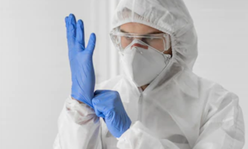 Doctor wearing a face mask and surgical gloves
