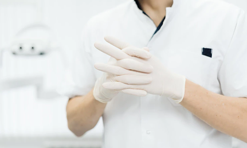 Doctors hands in exam gloves